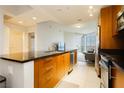 Well-equipped kitchen featuring stainless steel appliances and a sleek design, seamlessly flowing into the living area at 200 W Sahara Ave # 910, Las Vegas, NV 89102