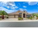 A beautiful single-Gathering home featuring a three-car garage and well-manicured landscaping at 2168 Big Bar Dr, Henderson, NV 89052