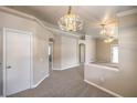 Spacious living area with neutral tones, plush carpeting, and decorative lighting fixtures at 2177 Hidden Ranch Ter, Henderson, NV 89052