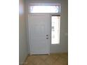 The foyer boasts neutral paint, tile flooring, and a decorative transom window above the entry door at 2905 Shimmering Bay St, Laughlin, NV 89029