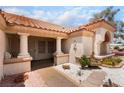 Inviting home entrance with stone accents, desert landscaping, and a tranquil fountain feature at 3109 Moongold Ct, Las Vegas, NV 89134