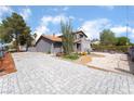 This Desert Modern home features interesting xeriscaping and a tiled roof at 3400 Sioux Way, Las Vegas, NV 89169