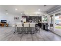 Open-concept kitchen with breakfast bar, ceramic tile and stainless steel appliances at 3400 Sioux Way, Las Vegas, NV 89169