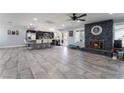 Spacious, open concept, living room with fireplace, kitchen, ceiling fan and ceramic tile at 3400 Sioux Way, Las Vegas, NV 89169