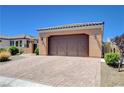 Single-story home showcasing a brick paver driveway, a two-car garage, and desert landscaping at 3616 Greenbriar Bluff Ave, North Las Vegas, NV 89081