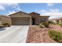 Inviting single-story home with desert landscaping, a two car garage, and stone accents at 5375 E La Campana Dr, Pahrump, NV 89061