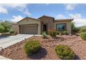 Charming single-story home with a two car garage, desert landscaping and stone accents at 5375 E La Campana Dr, Pahrump, NV 89061