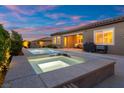 Inviting backyard with a sparkling pool and hot tub, patio with grill, and seamless indoor-outdoor living at 6192 Lautman Ridge Ct, Las Vegas, NV 89141