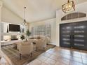 Open-concept living room featuring a fireplace, high ceilings, neutral tones, and contemporary furnishings at 6639 Tranquil Seas Ct, Las Vegas, NV 89139