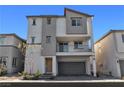 Inviting three-story townhome featuring a balcony, a two-car garage, and modern design at 6952 Crescent Gold St, North Las Vegas, NV 89086