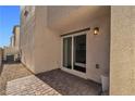 Paver patio with sliding glass door access, perfect for outdoor relaxation and entertainment at 6952 Crescent Gold St, North Las Vegas, NV 89086