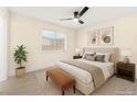 Well-lit bedroom with a ceiling fan, cozy bed, and stylish furnishings at 7566 Glowing Ember Ct # 101, Las Vegas, NV 89130