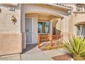 Charming front porch with a cozy bench, security gate, and views of the neighborhood at 7886 Palace Monaco Ave, Las Vegas, NV 89117
