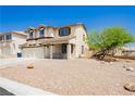 Attractive two-story home with stucco exterior, covered porch, and low maintenance gravel front yard at 8224 Cassis Ct, Las Vegas, NV 89117
