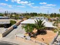 Inviting exterior of a single-story home with a private yard, palm tree, decorative fence, and desert landscaping at 829 Dover Pl, Las Vegas, NV 89107