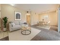 Comfortable living area with a sofa, coffee table, and dining set, perfect for relaxing and entertaining at 830 Carnegie St # 824, Henderson, NV 89052