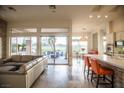 Open living space with tile floors, a view to the patio, and breakfast bar seating at 9 Knob Oak Dr, Henderson, NV 89052
