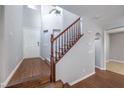 Bright foyer with staircase, hardwood floors, and a view of the front door at 9005 Semillon St, Las Vegas, NV 89148