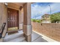 Inviting front porch features a secure door and a charming welcome mat for a warm entry at 9005 Semillon St, Las Vegas, NV 89148