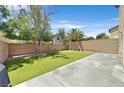 Backyard with artificial turf grass, providing a low-maintenance outdoor space at 9105 White Eyes Ave, Las Vegas, NV 89143