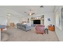 Bright, neutral living room featuring modern ceiling fan, vaulted ceilings, and an open floor plan at 9105 White Eyes Ave, Las Vegas, NV 89143