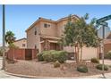 Lovely exterior corner with manicured landscaping, stone accents, and two-car garage at 9853 Bangalore Ct, Las Vegas, NV 89148