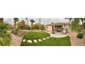 Expansive backyard with artificial grass, paved patio, and landscaped area, perfect for outdoor enjoyment at 10248 Maggira Pl, Las Vegas, NV 89135