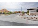 Cascades community entrance featuring manicured landscaping and contemporary signage against a cloudy sky backdrop at 11840 Pelican Butte Ave, Las Vegas, NV 89138