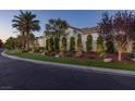 Exterior view of modern home with desert landscaping, lawn and trimmed trees at 11926 Port Labelle Dr, Las Vegas, NV 89141