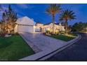Elegant, light colored home featuring beautiful landscaping and a circular driveway at 11926 Port Labelle Dr, Las Vegas, NV 89141