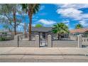 Charming single-story home with secure fencing, mature trees, and a well-maintained front yard at 1608 E Mcdonald Ave, North Las Vegas, NV 89030