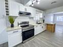 Bright kitchen with stainless steel appliances, subway tile backsplash, white cabinets, and breakfast bar at 1608 E Mcdonald Ave, North Las Vegas, NV 89030