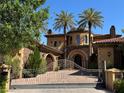 Stunning two-story Mediterranean-style home with a gated entrance and lush landscaping at 1800 Amarone Way, Henderson, NV 89012