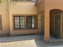 Attractive exterior showcasing covered entryway with security doors, and maintained desert landscaping at 2041 Hussium Hills St # 104, Las Vegas, NV 89108