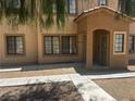 Charming exterior featuring a covered entrance and well-maintained landscaping with desert surroundings at 2041 Hussium Hills St # 104, Las Vegas, NV 89108