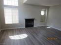 Bright living room with wood flooring, fireplace, and lots of natural light at 208 Genesee Point St, Henderson, NV 89074