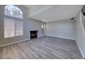 Spacious living room features vaulted ceilings, a fireplace, and large windows for plenty of natural light at 208 Genesee Point St, Henderson, NV 89074