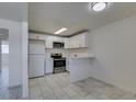 Open kitchen space features white cabinets, stainless steel appliances, and modern flooring at 212 Orland St # 28, Las Vegas, NV 89107