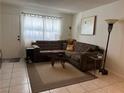 Comfortable living room with a large sectional sofa, accent pillows, and natural lighting at 2136 Bavington Dr # A, Las Vegas, NV 89108