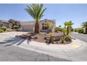 Beautiful single-story home with desert landscaping and a two car garage at 2221 River Grove Dr, Henderson, NV 89044