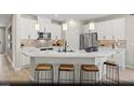 Bright kitchen with white cabinets, stainless steel appliances, quartz countertops, and pendant lighting at 2615 Regency Cove Ct # Lot 13, Las Vegas, NV 89121