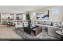 Spacious living room with a plush sofa, accent chairs, and an open view to the kitchen at 2615 Regency Cove Ct # Lot 13, Las Vegas, NV 89121
