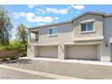 Attractive stucco townhome with two-car garage, balcony, and manicured landscaping at 2860 Sunflower Days Ave # 2141, North Las Vegas, NV 89031