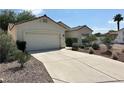 Attractive single-story home with a two-car garage and an extended driveway nestled in a desert landscape at 316 Lingering Ln, Henderson, NV 89012