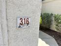 Close-up of house number on textured exterior wall at 316 Lingering Ln, Henderson, NV 89012