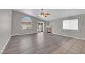 Bright living room with hardwood floors, large windows, and cozy fireplace feature at 3228 Jumping Hills Ave, Henderson, NV 89052