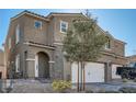 Charming exterior view of a home featuring a private entrance and attached two-car garage at 377 Yellow Finch Ln, Henderson, NV 89012