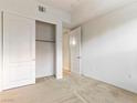 Bedroom with carpet, empty closet with double door, and white door at 38 E Serene Ave # 134, Las Vegas, NV 89123