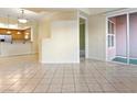 Open-concept living room with tile floor and sliding glass doors at 38 E Serene Ave # 134, Las Vegas, NV 89123