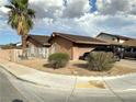 Exterior of a single-Gathering home showcasing desert landscaping, block wall and a two car garage at 3936 Rive Gauche St, Las Vegas, NV 89115